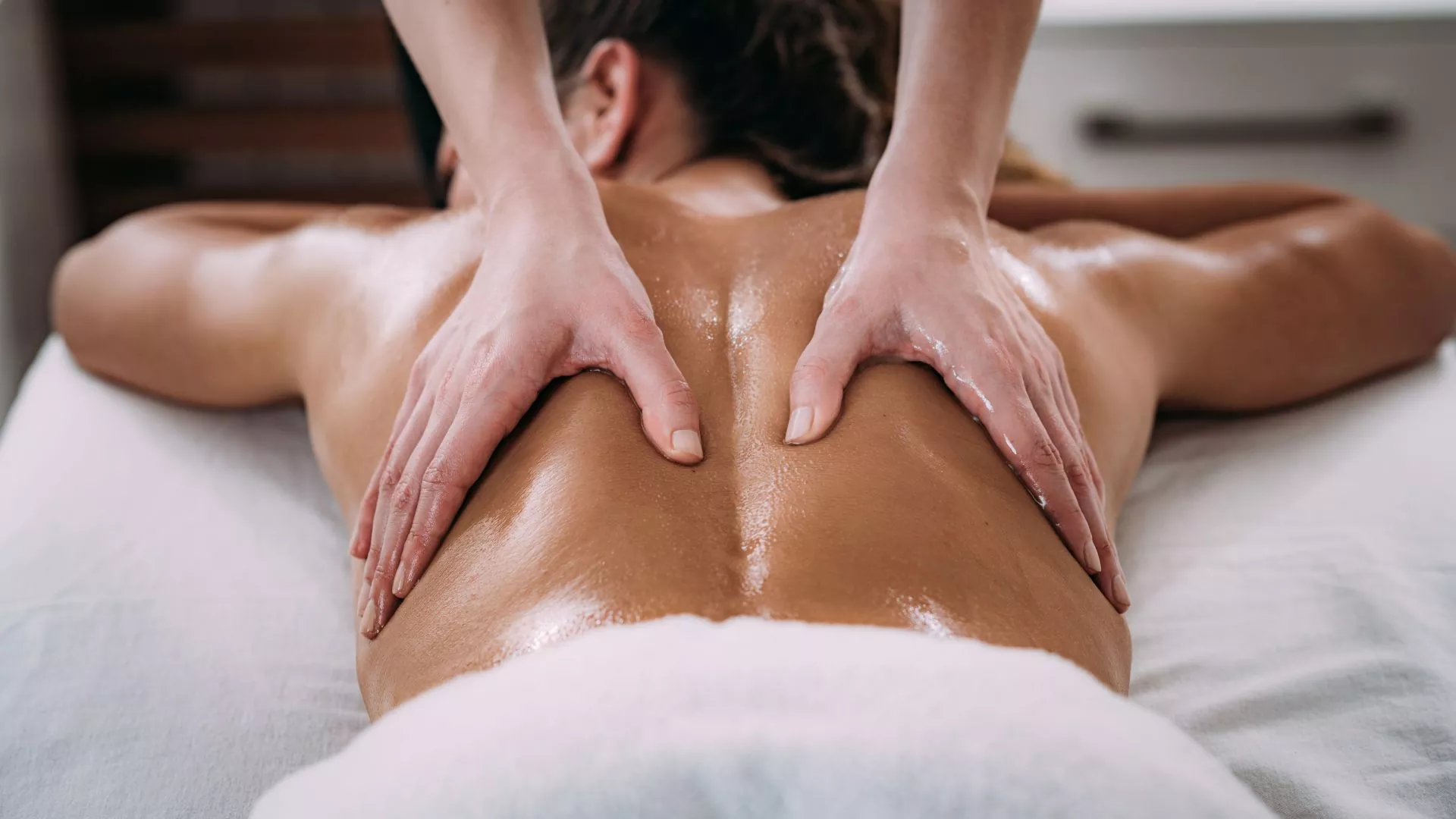 Therapist performing a back massage