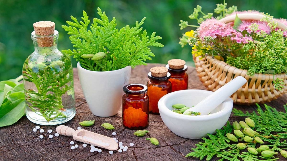 Herbal remedies, mortar and pestle on a wooden surface